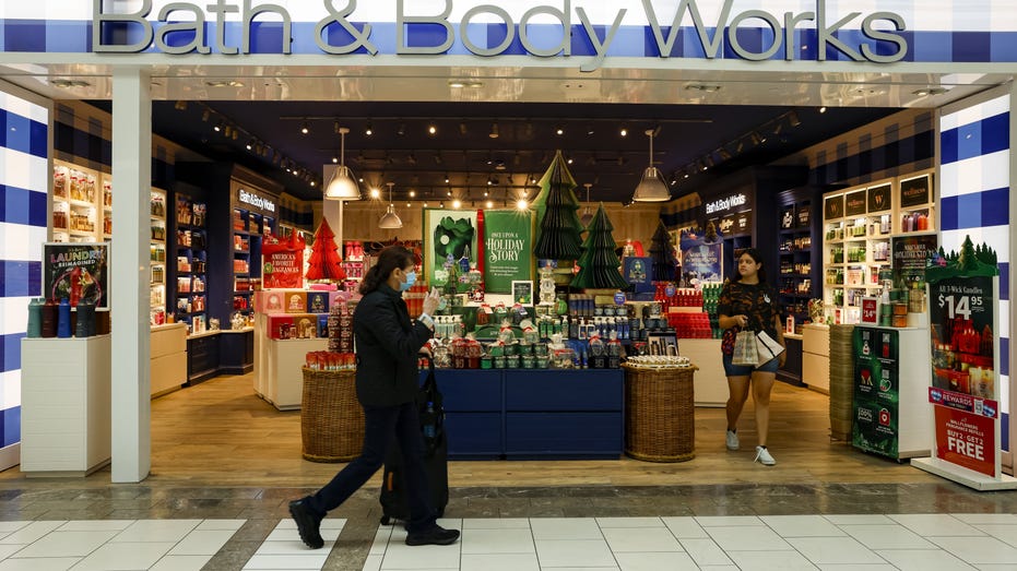 Shoppers walk by a Bath & Body Workers in a Miami mall