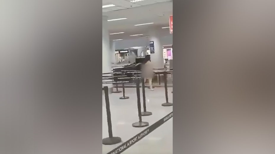 A naked woman is seen walking through security at Ninoy Aquino International Airport.