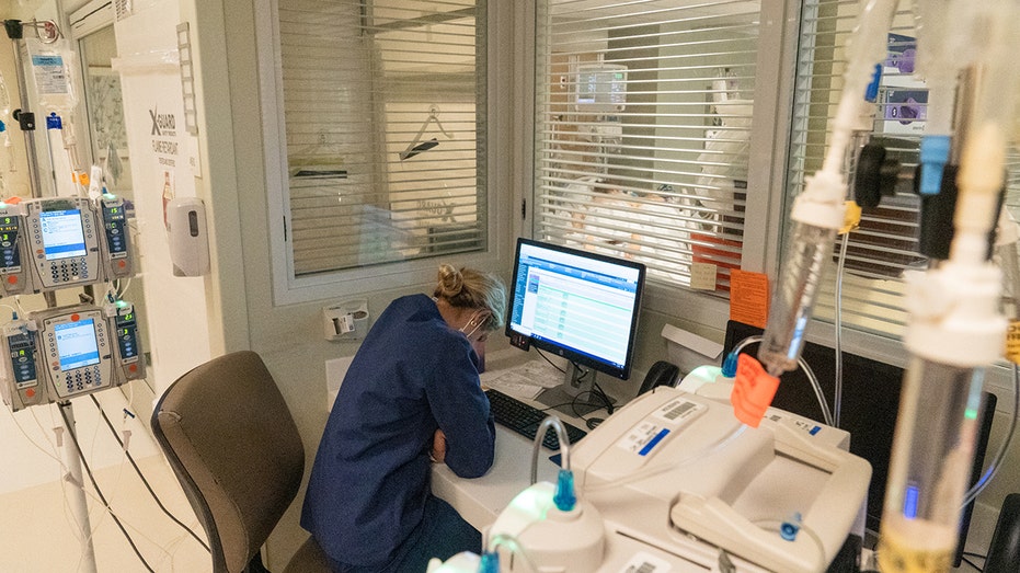 A nurse works outside a negative pressure room in the Covid-19 Intensive Care Unit (ICU) of Sharp Memorial Hospital in San Diego, Calif., on Jan. 28, 2021.