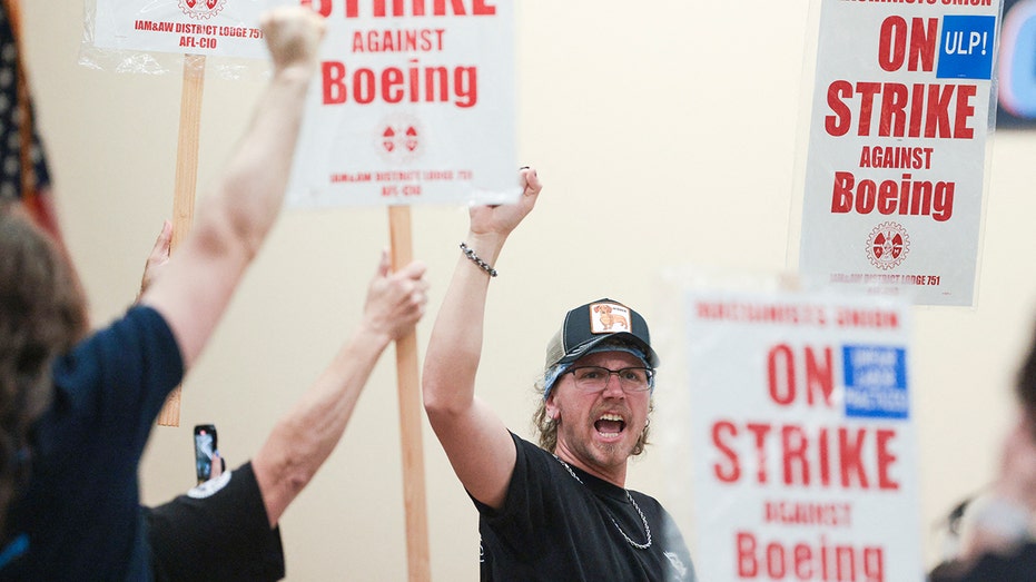 Boeing worker holds up fist during labor union strike