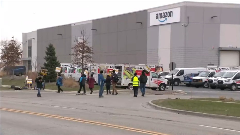 amazon workers strike outside warehouse building