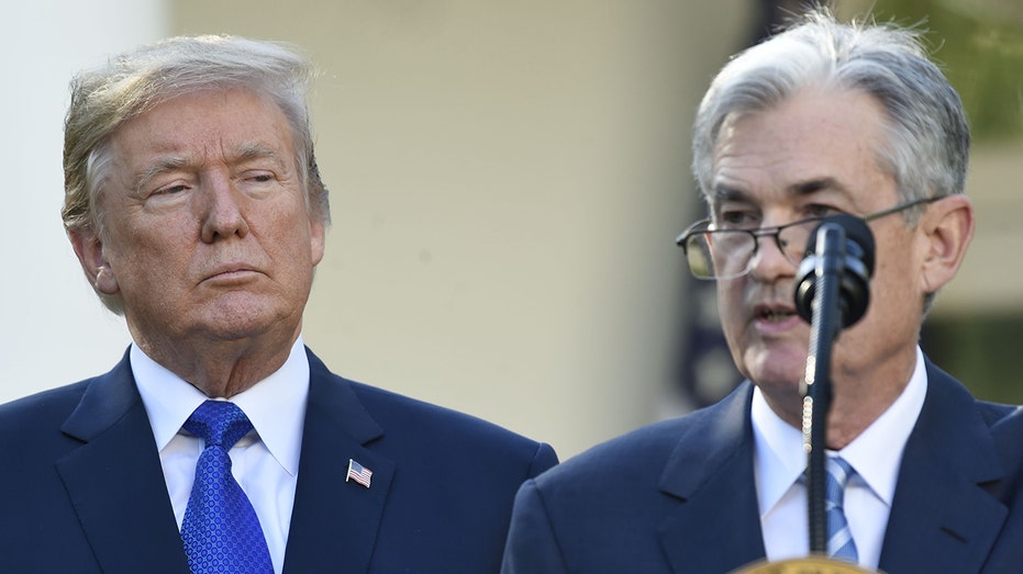 Trump looks while Jerome Powell speaks