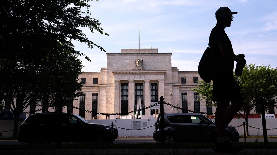 The Federal Reserve building in Washington DC with a person walking past