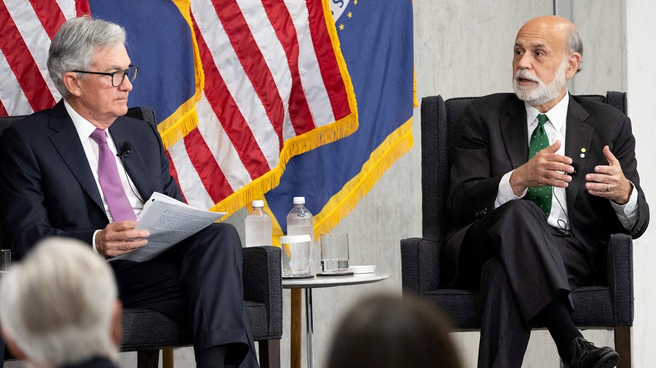 Jerome Powell and Ben Bernanke speak during an event