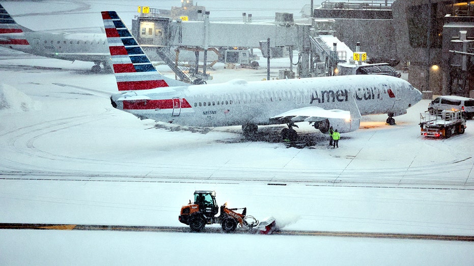 American Airlines aircraft at snowy LaGuardia Airport