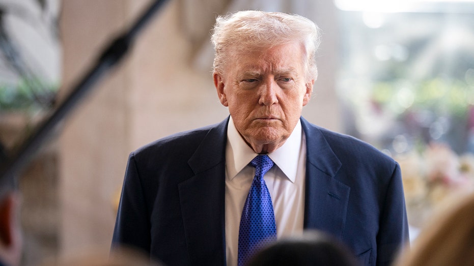 The president stands outdoors addressing journalists gathered with cameras and microphones.