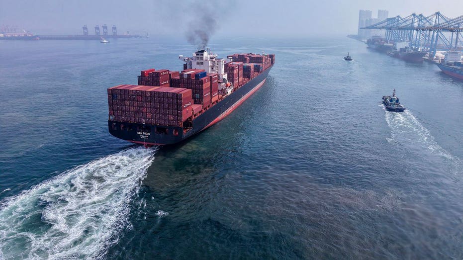 A cargo ship sets sail.